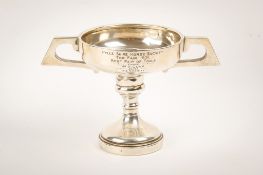 An Art Deco twin-handled weighted silver trophy.