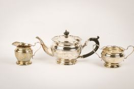 An early 20th century silver teapot, sugar bowl and cream jug set.