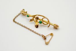 A 15ct gold and stone set bar brooch.