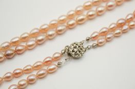 A double strand of pale pink freshwater pearls.