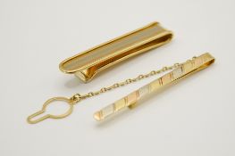 Two 18ct gold tie clips. With tricolour patterns, both marked 750, gross weight 17.34g.