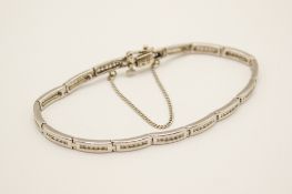 A 9ct white gold and diamond bracelet.