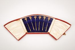 A set of six enamelled silver picks.