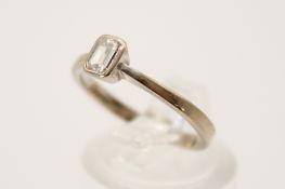 An 18ct gold and diamond solitaire ring. Of emerald cut type form, circa 3.2mm x 4.