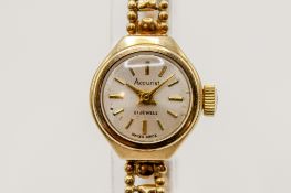 A lady's Accurist 9ct gold wristwatch. Gilt markers to the circular face, case measuring 1.7cm x 0.