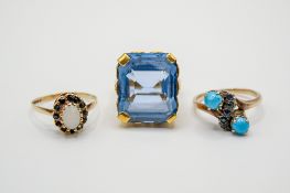 Three gold and yellow metal stone set rings.
