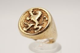 A 9ct gold signet ring with rampant lion motif.