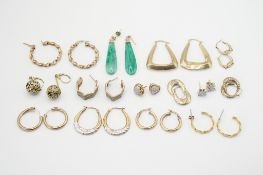 A small group of gold and yellow metal earrings.