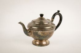 A 1930s silver teapot.