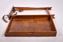 A 19th century mahogany butlers tray on a folding stand. The oblong tray having twin handles, L75cm.