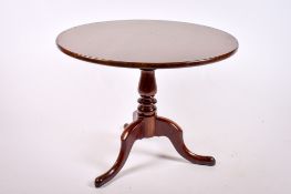 A 19th century mahogany snap top supper table on tripod base.