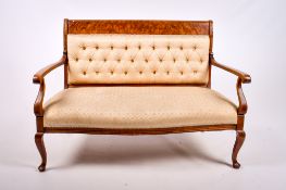 A late 19th century mahogany framed open arm settee.