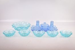 A collection of coloured pressed glassware.