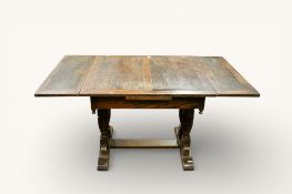 A 20th century oak draw leaf dining table. Having baluster supports united by a stretcher.