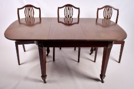 A 20th century extendable mahogany dining table and a set of six chairs.
