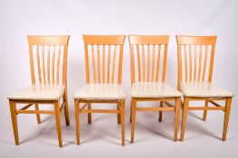 A set of four Italian stick back dining chairs.