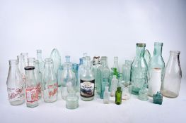A collection of assorted glass storage bottles, some of local interest.