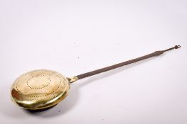 A vintage bed warmer. Having a metal handle and brass cover with impressed decoration, L97.5cm.