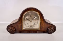 A 1930s oak cased Napoleon hat style mantel clock.