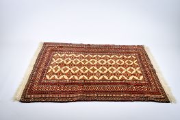 A Turkoman style wool rug.