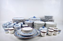 A large collection of assorted blue and white ceramic tableware.