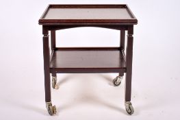 A 20th century stained mahogany tea trolley.