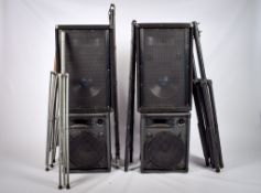 An assortment of electric musical equipment. Including a pair of large PA speakers, etc.