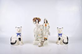 Four Victorian Staffordshire pottery items. Including a pair of cats, etc.
