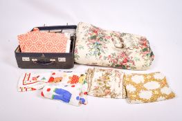 A collection of assorted modern fabric and a bedspread.
