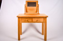 A contemporary blonde oak dressing table with a separate mirror.