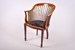 An Edwardian mahogany inlaid open arm tub chair.