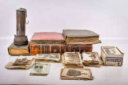 A collection of assorted postcards, photographs and collectables.