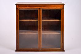 A 20th century mahogany glazed bookcase.