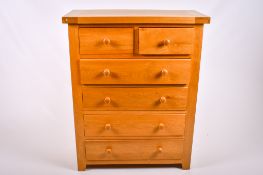 A contemporary light oak chest of drawers.