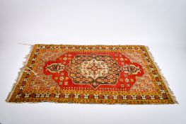 An Indian hand knotted wool rug with bold geometric patterns.