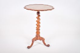 A Victorian walnut tripod side table.