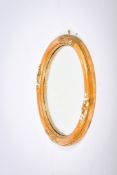 A vintage circular convex wall mirror. In a moulded gilt frame with floral decoration, Diameter 48.