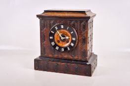 A late 19th century Black Forest walnut cased mantel clock.