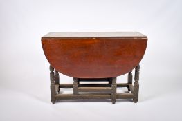 A 19th century gateleg dining table with a later top.