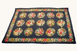 The Rug Shop Tunbridge Wells wool throw floral design on a black ground.