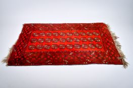 A hand-knotted Afghan Bokhara wool rug.