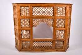 A Far Eastern teak carved and pierced screen.