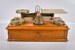 A set of Parkins & Gotts brass postal scales and weights.