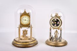 Two lacquered brass anniversary clocks beneath glass domes.