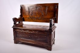 A mid 20th century oak monk's bench. Having storage beneath. H69cm x W106cm x D47cm (closed).