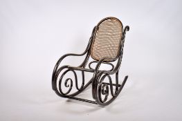 A Thonet style mid-century bentwood rocking chair. With a cane work back and seat, H88cm (AF).