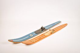 Two vintage laminate single water skis.