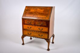 A 20th century Queen Anne style mahogany bureau.