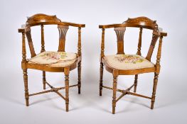 A pair of Edwardian inlaid mahogany corner chairs.