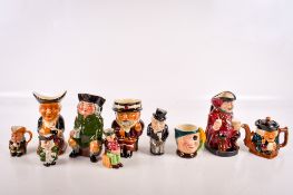 Ten ceramic jugs, mostly 'Toby' style. Including Royal Doulton 'Falstaff'. Largest H13.